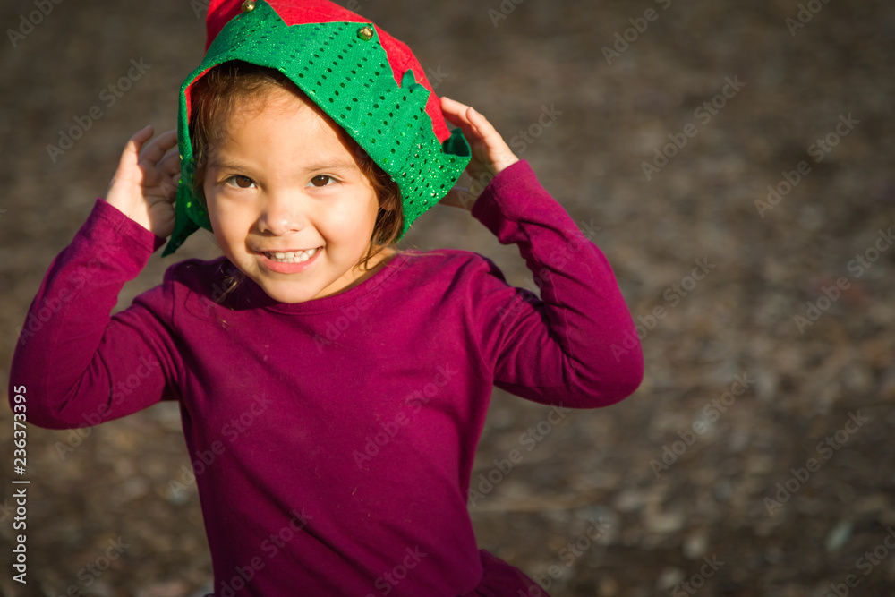 Cute Mixed Race Young Baby Girl Having Fun Wearing Christmas Hat Outdoors Cute Mixed Race Young Baby Girl Having Fun Wearing Christmas Hat Outdoors