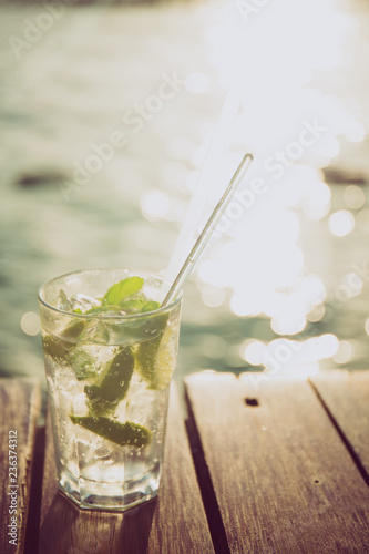 Cocktail at the wooden pier during sunset. Luxury vacation resort. Holiday getaway concept