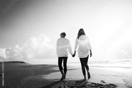 happy couple running on the beach.Young couple in love walking on the sand by the sea