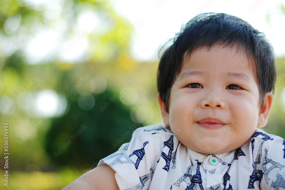 Portrait of a cute little Asia boy smiling . Portrait of young boy in nature,park or outdoors.