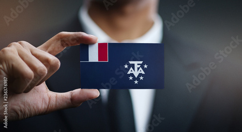 Businessman Holding Card of French Southern Flag photo