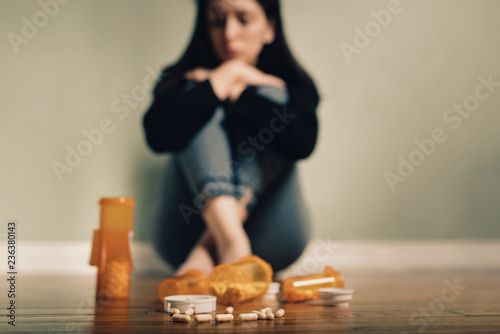 Caucasian female contemplating take prescription pills photo