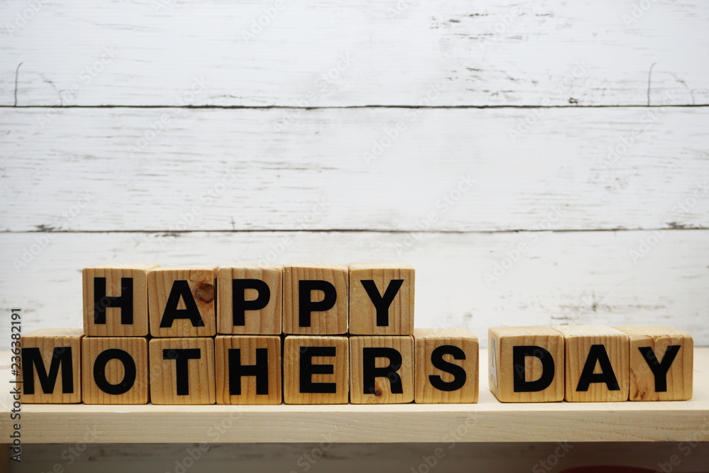 Happy Mother's Day concept with alphabet letters on space wooden background