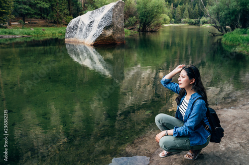 woman kneeling down relaxing at mirror lake
