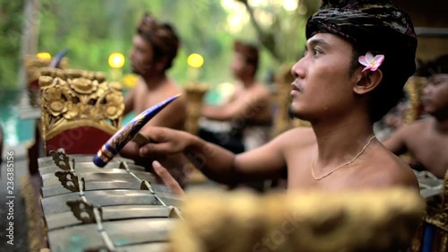 Asian Balinese musician gamelan group playing in traditional dress in a ceremonial celebration performance Indonesia South East Asia photo