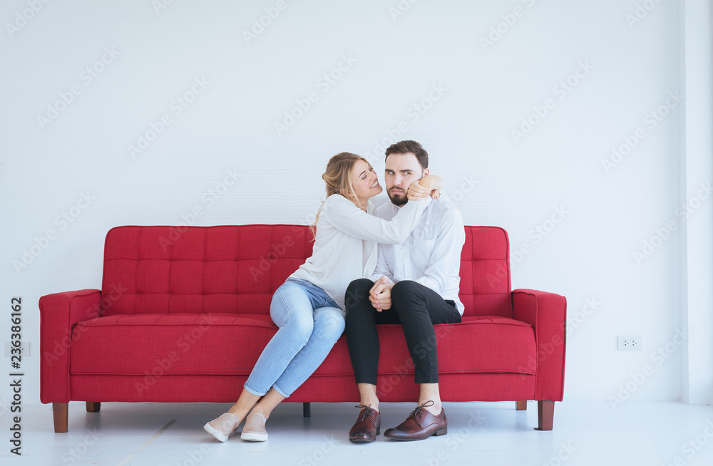Obraz premium Wife reconcile her touchy husband and hugging couple in love at the living room,Positive attitude emotions.