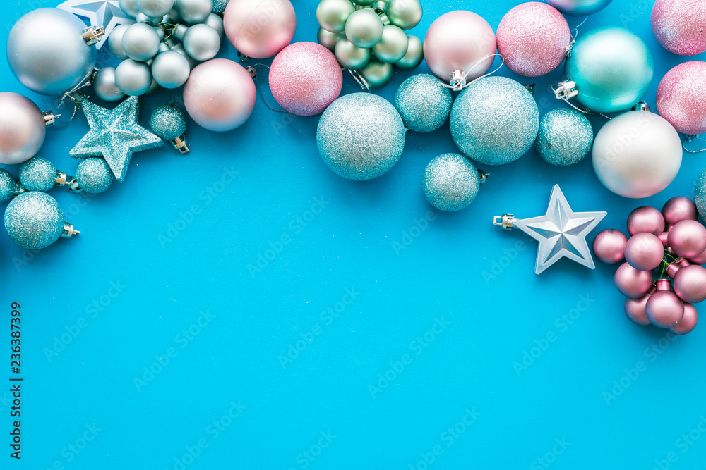 Toys for New Year tree 2019 background. Blue and pink balls and stars on blue background top view copy space border Toys for New Year tree 2019 background. Blue and pink balls and stars on blue background top view copy space border