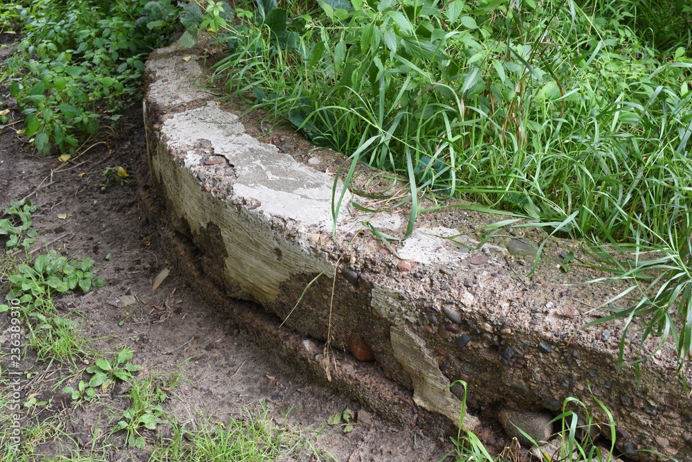 Stone wall overgrown with grass Stone wall overgrown with grass
