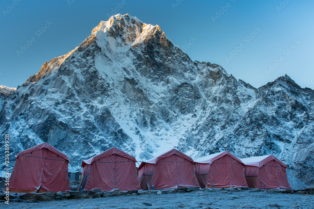 Group of climbers ' bright color tents on the Khumbu glacier in area of  Everest base camp