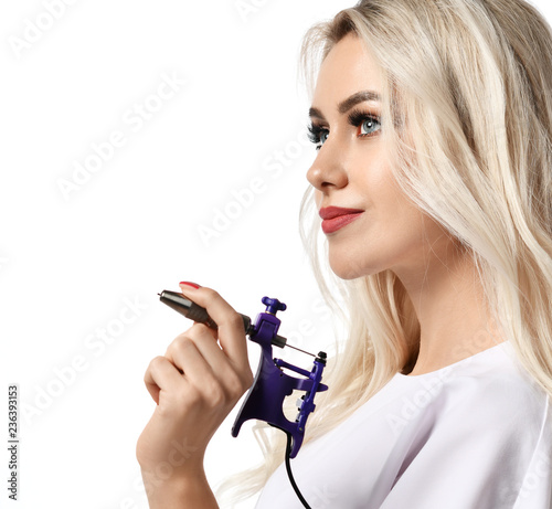 Woman beautician cosmetologist hold tattoo machine gun isolated on white