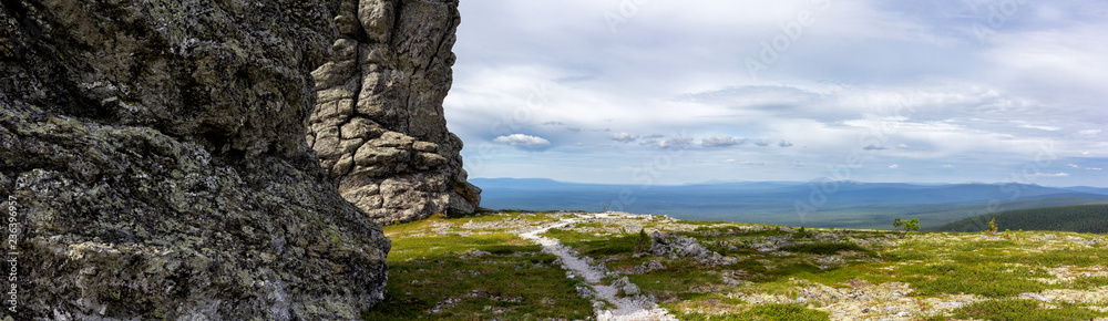 Magnificent panorama of the stone idols of Manpupunyor in the Northern Urals of Russia. Panoramic view of the miracle of Russia.