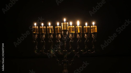 The 8th day of the Jewish holiday of Hanukkah. Beautiful Lit Hanukkah Menorah On Dark Background