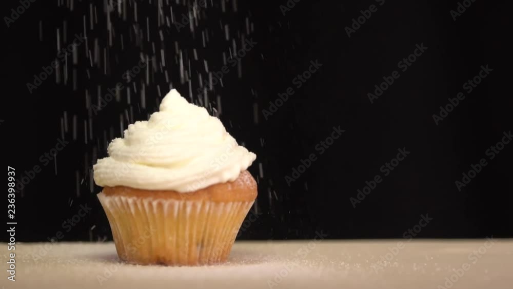 Pastry sprinkles on the cupcake icing sugar. Slow motion
