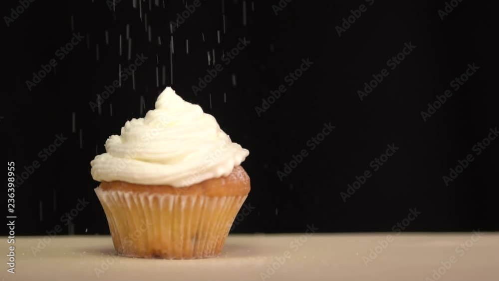 Pastry sprinkles on the cupcake icing sugar. Slow motion