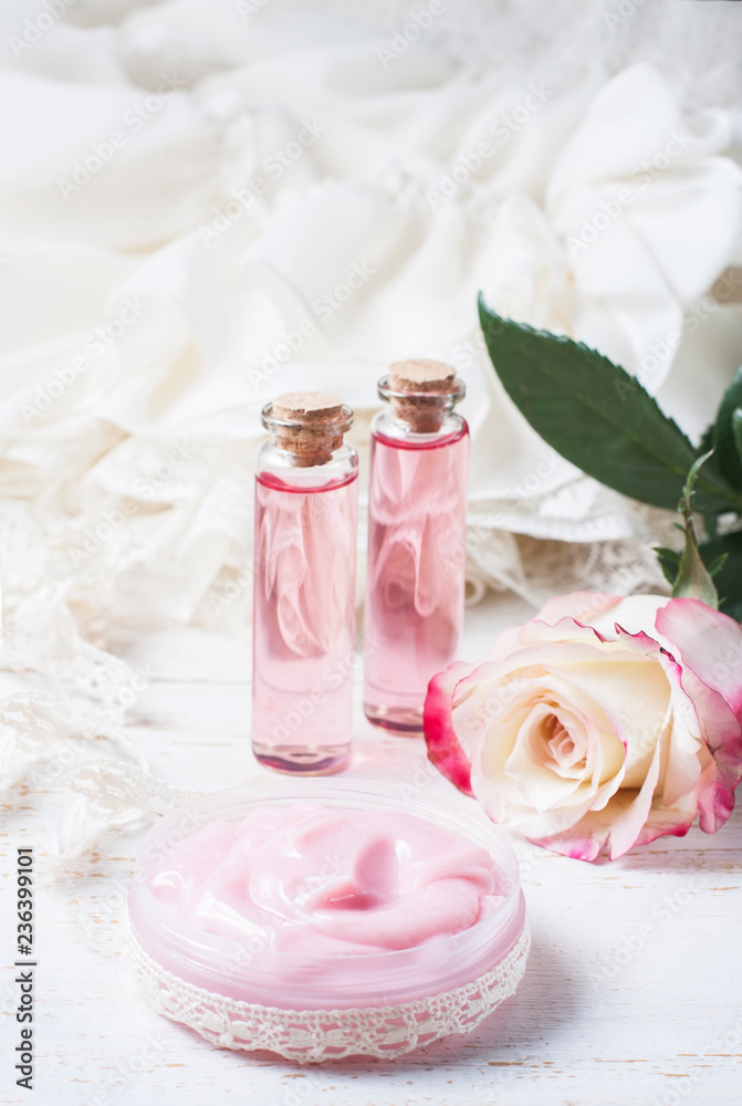 cosmetic cream with pink roses on a wooden table cosmetic cream with pink roses on a wooden table