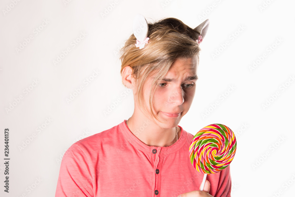 Young attractive guy and sweet candy. 