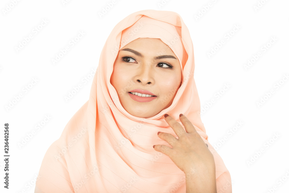 Smiling girl in hijab covering beautiful with happiness and color wall Smiling girl in hijab covering beautiful with happiness and color wall