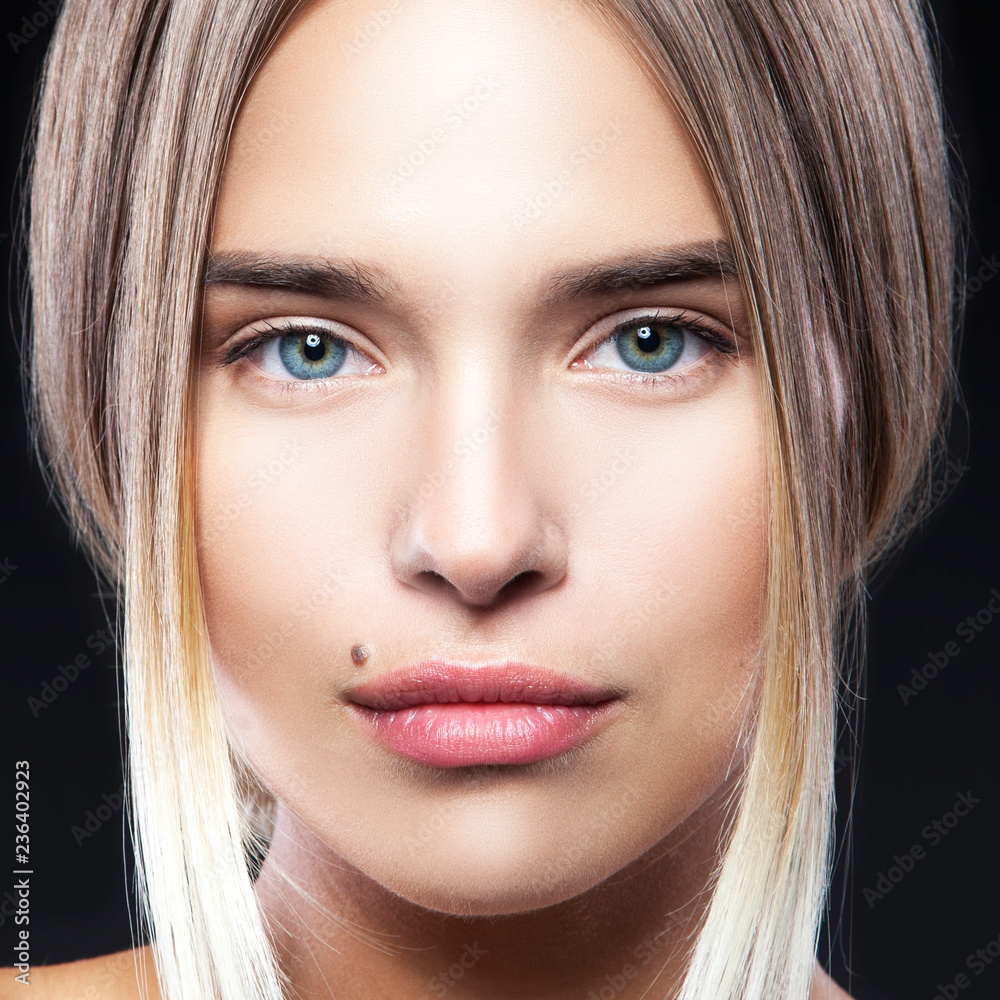 Beauty model girl face close-up. Attractive woman ith perfect clean skin,  beauty spot near mouth, natural lips, nude make-up, hairstyle. Black  bckground Stock Photo | Adobe Stock