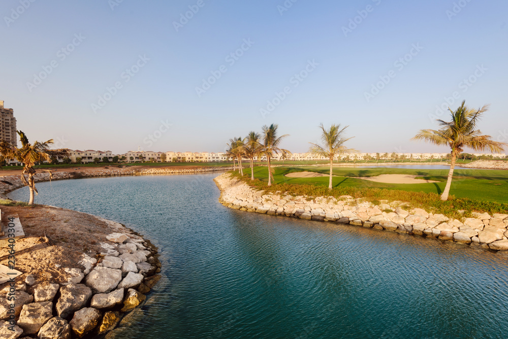 September 12, 2017 - Al Hamra Village in Ras al Khaimah, United Arab Emirates. Modern arabian village with houses and palms on Persian gulf shore. September 12, 2017 - Al Hamra Village in Ras al Khaimah, United Arab Emirates. Modern arabian village with houses and palms on Persian gulf shore.