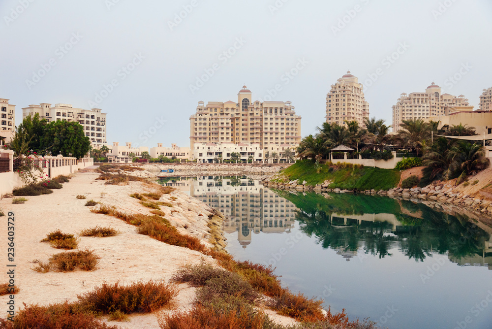 September 16, 2017 - Al Hamra Village in Ras al Khaimah, United Arab Emirates. Modern arabian district area with apartment buildings, palms and hotels in Persian gulf. September 16, 2017 - Al Hamra Village in Ras al Khaimah, United Arab Emirates. Modern arabian district area with apartment buildings, palms and hotels in Persian gulf.
