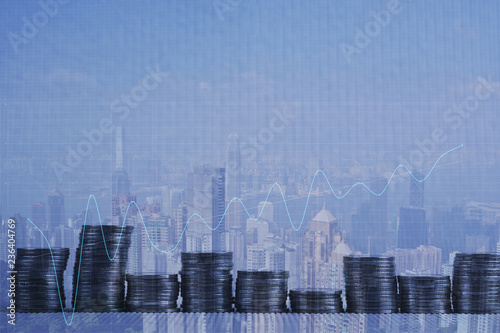 Double exposure Stack of coin with financial graph over city and office building background  business and financial concept.