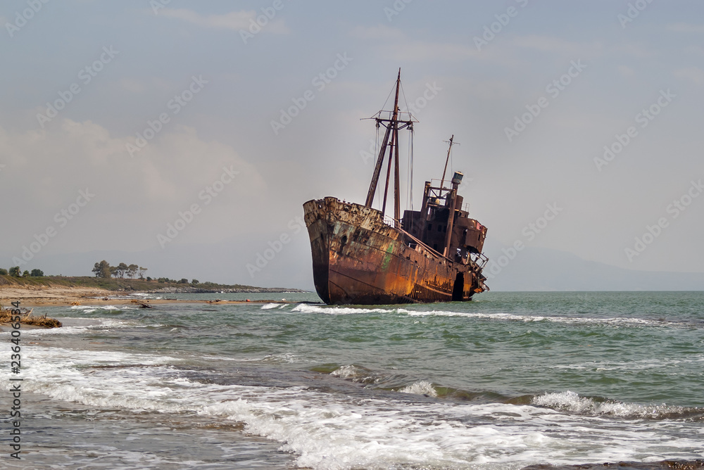 An old rusty ship that is thrown into a shallow water near the Glyfada beach. Shipwreck Dimitrios at Laconia, near Gythio, Peloponessеs, Greece.Photo taken September 2018. An old rusty ship that is thrown into a shallow water near the Glyfada beach. Shipwreck Dimitrios at Laconia, near Gythio, Peloponessеs, Greece.Photo taken September 2018.