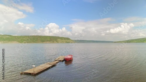 A nice scenic view on wide river with small red rescue boat photo