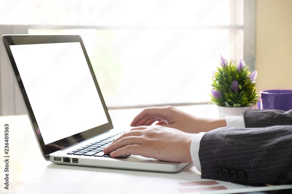 Businessman using laptop computer, cropped shot hand using mockup laptop empty screen display for present. Businessman using laptop computer, cropped shot hand using mockup laptop empty screen display for present.