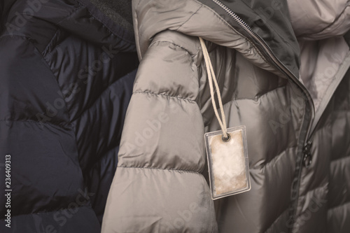 Small transparent plastic bag with winter jacket's filling (down) sample. Choosing qualitative filling for winter clothes.