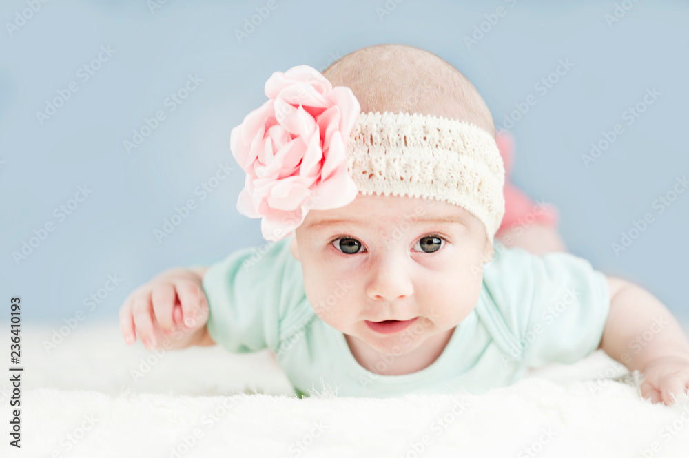 very beautiful baby learns to crawl, he has saliva on an isolated background