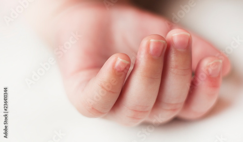 hands sleeping newborn baby close up on white background