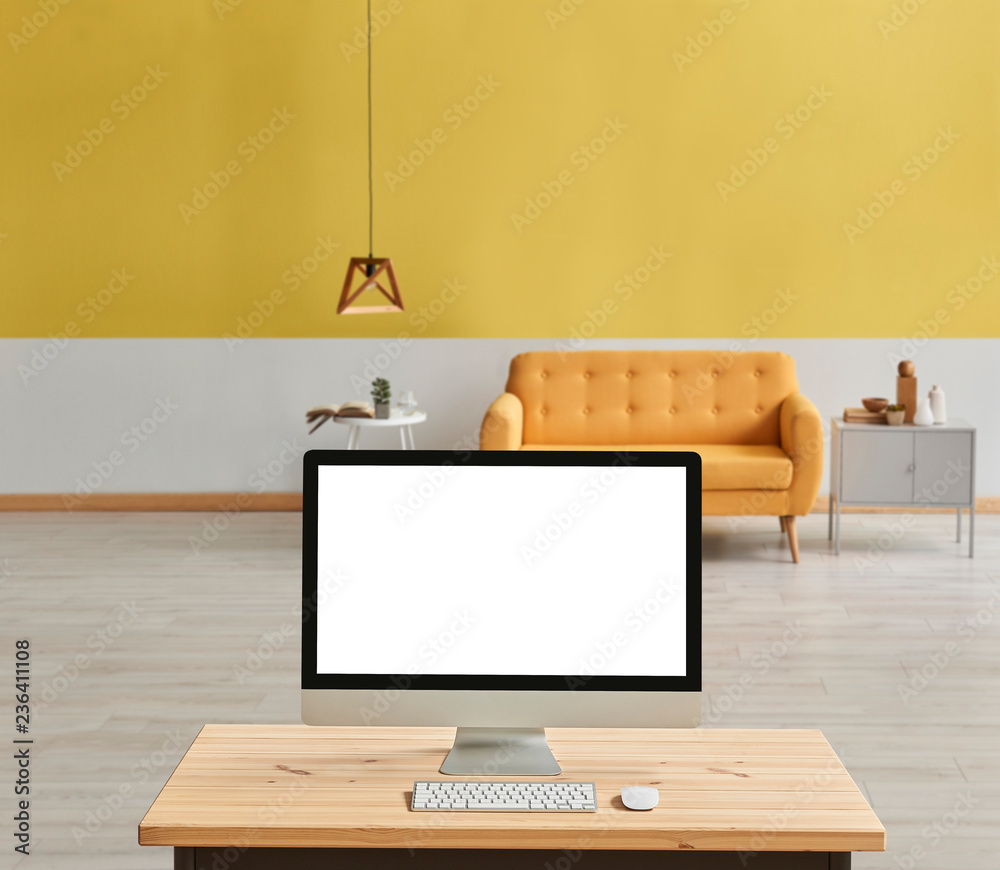 Yellow living room with yellow sofa and wooden lamp blur background, close up desktop screen on the wooden desk. Yellow living room with yellow sofa and wooden lamp blur background, close up desktop screen on the wooden desk.