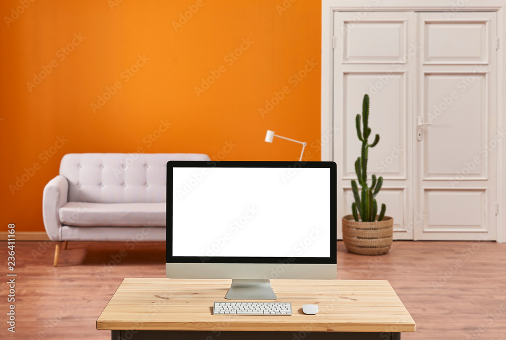 Orange living room, sofa and white classic door, close up desktop screen on the wooden desk. Orange living room, sofa and white classic door, close up desktop screen on the wooden desk.
