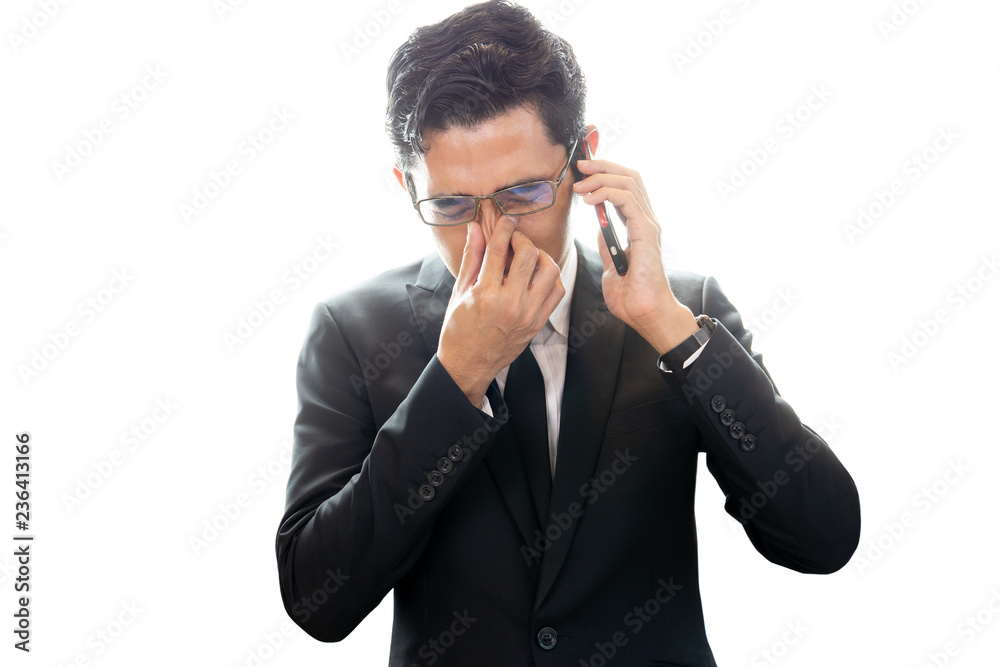 Asian businessman looking depressed while talking on cellphone isolated. Asian businessman looking depressed while talking on cellphone isolated.