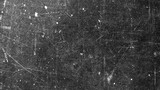 Texture of old surface on black background with white scratches