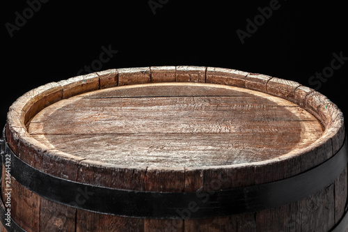 Old wooden barrel on a dark background © NewFabrika