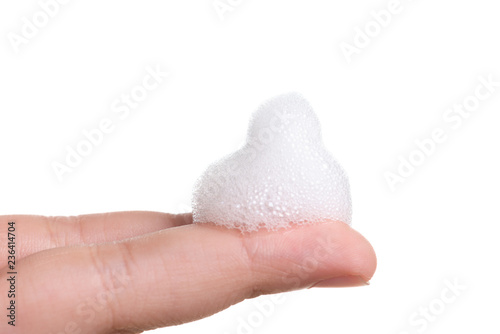 White foam bubbles texture with child finger and hand isolated on white