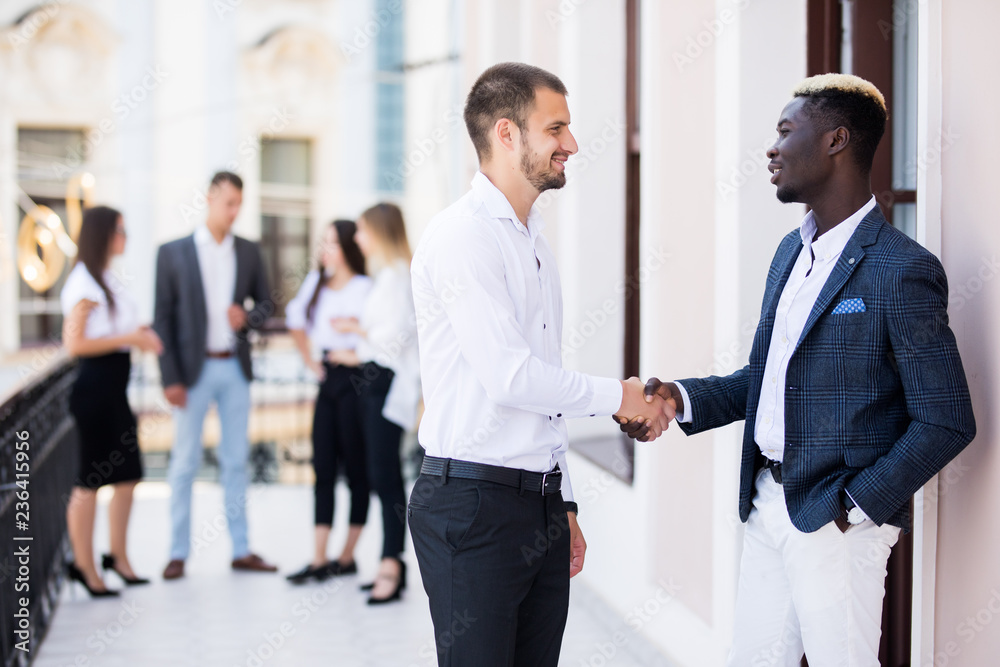 Handshake of business people at international business meeting in the office Handshake of business people at international business meeting in the office