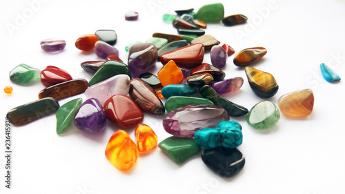 Fotografija Assorted natural bright coloured semi precious gemstones and gems on white backg