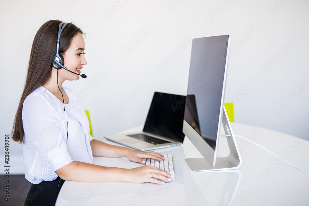 Young beautiful businesswoman with headset call center operator in office