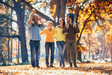 Multl generation family in autumn park having fun