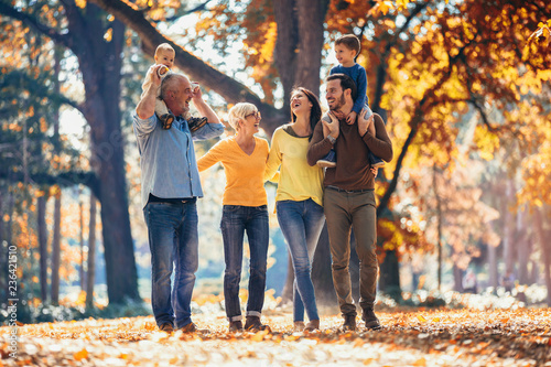 Multl generation family in autumn park having fun photo