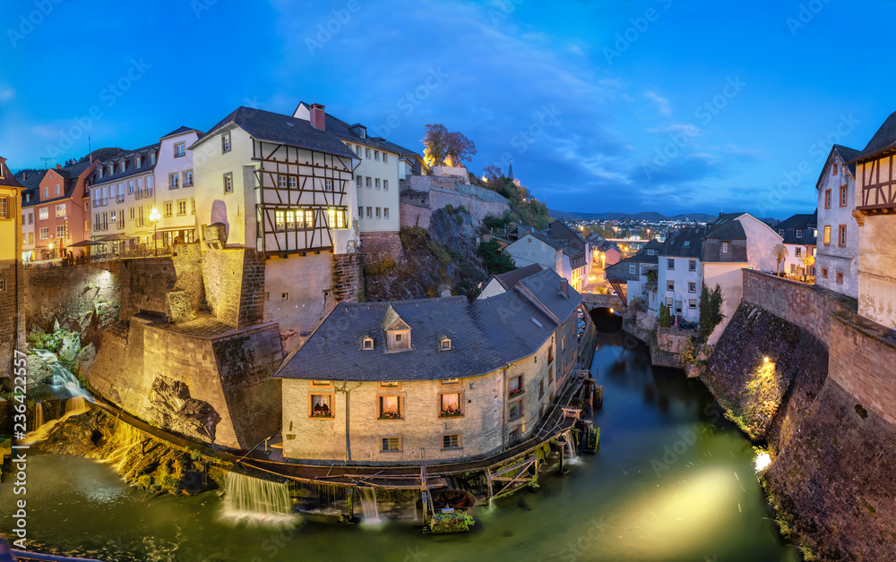 Saarburg, Germany. Cityscape with Leuk River and old historic watermills at dusk - obrazy, fototapety, plakaty 