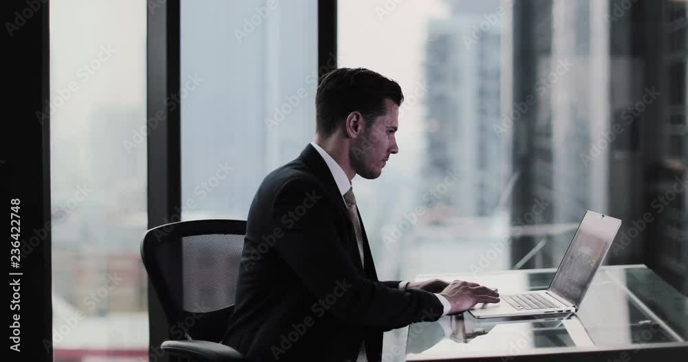 Businessman working in executive office in a skyscraper Businessman working in executive office in a skyscraper