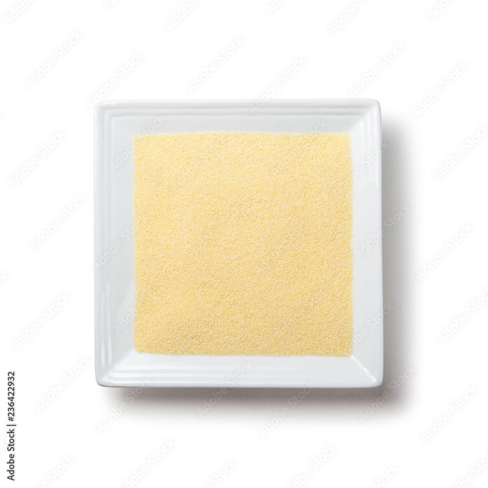 semolina on white square plate on white background with shadow isolated semolina on white square plate on white background with shadow isolated
