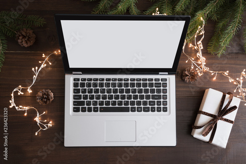 Screen laptop with space for text or special Christmas offer. Xmas shopping by laptop. Top view, flat lay. Holiday concept © svetlana_cherruty