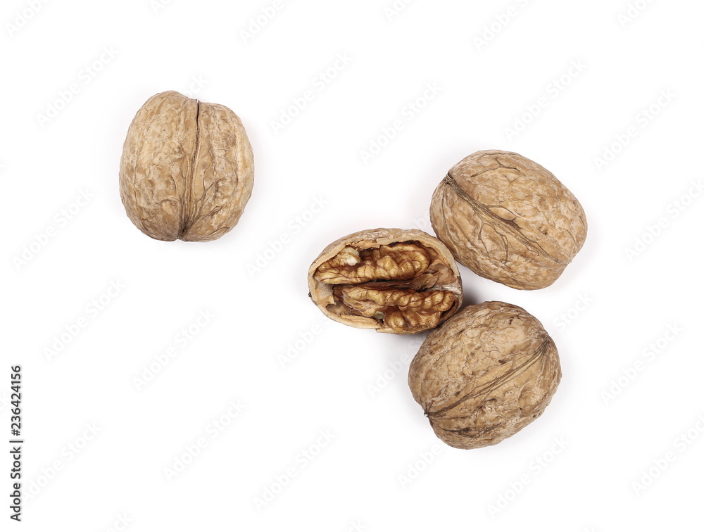Cracked walnuts, isolated on white background, top view