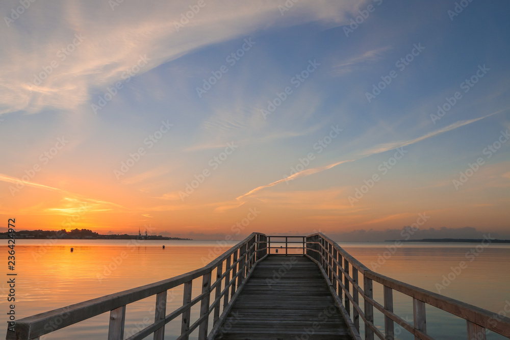 beautiful pier with romantic seascape at sunset