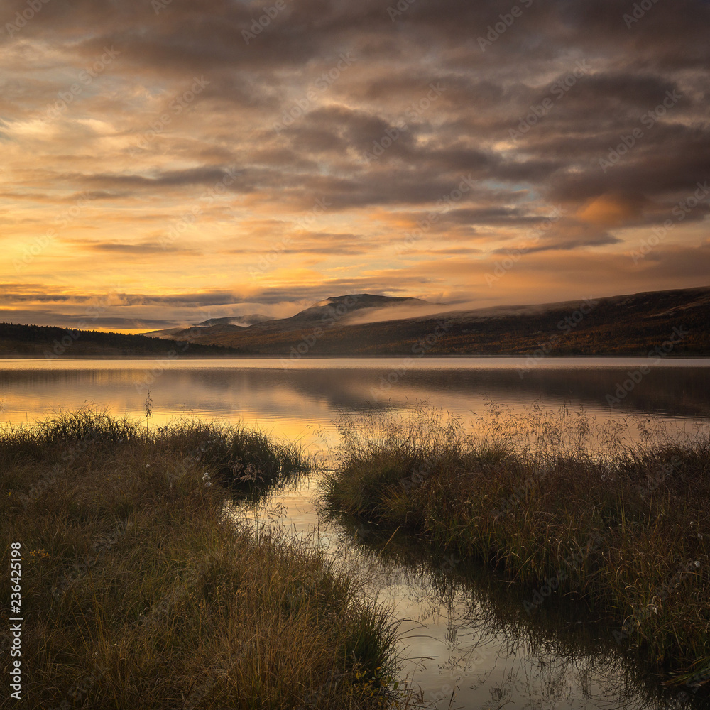 Sunrise over Hjerkinnsdammen lake, Dovre mountains. Sunrise over Hjerkinnsdammen lake, Dovre mountains.