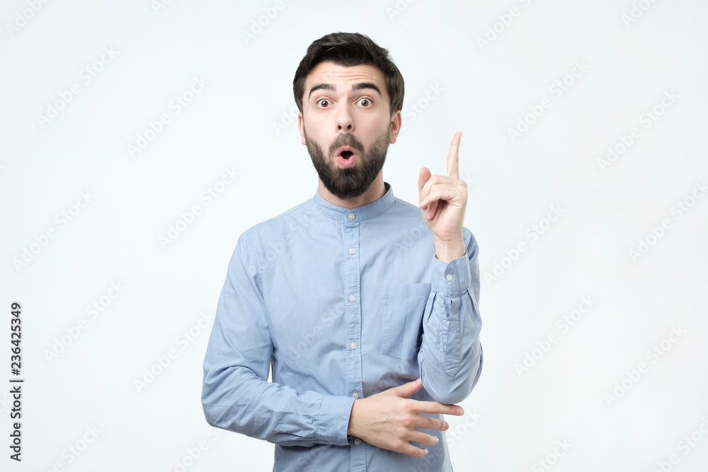 Happy man in blue shirt with opened mouth having a great idea and looking at camera. Happy man in blue shirt with opened mouth having a great idea and looking at camera.